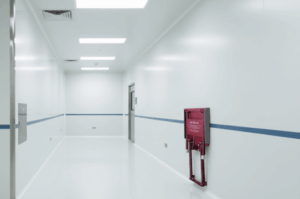 A Quick Seat Folding Chair Mounted to wall Outside Clean Room